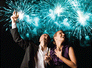Couple with champagne, calerating fireworks