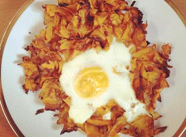 Paleo Sweet potato hash fried in coconut oil, topped with an egg